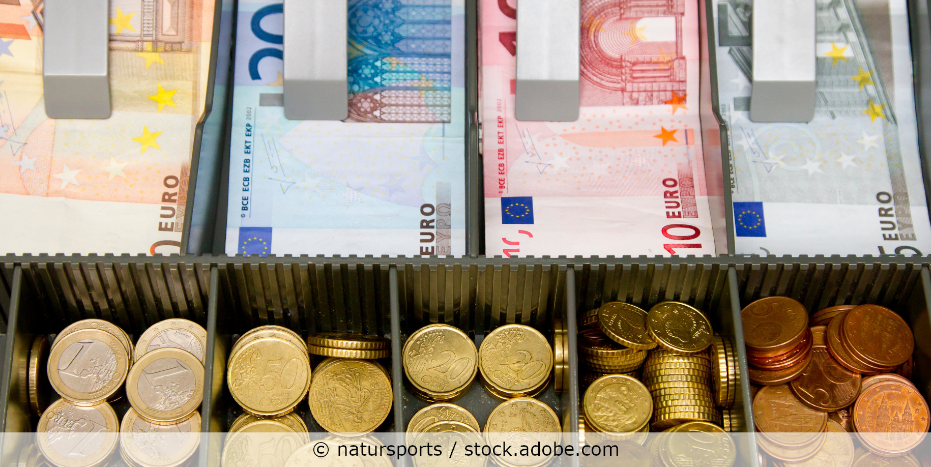 Blick von oben in eine Kassenlade mit Euro-Scheinen und Euro-Münzen.